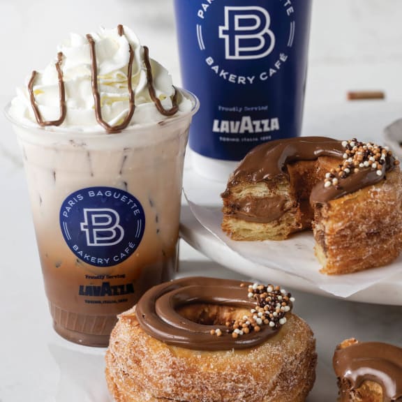 a selection of donuts and a cup of coffee and a donut with chocolate at Southpark on Whyte, Edmonton, Alberta, T6E 3S3