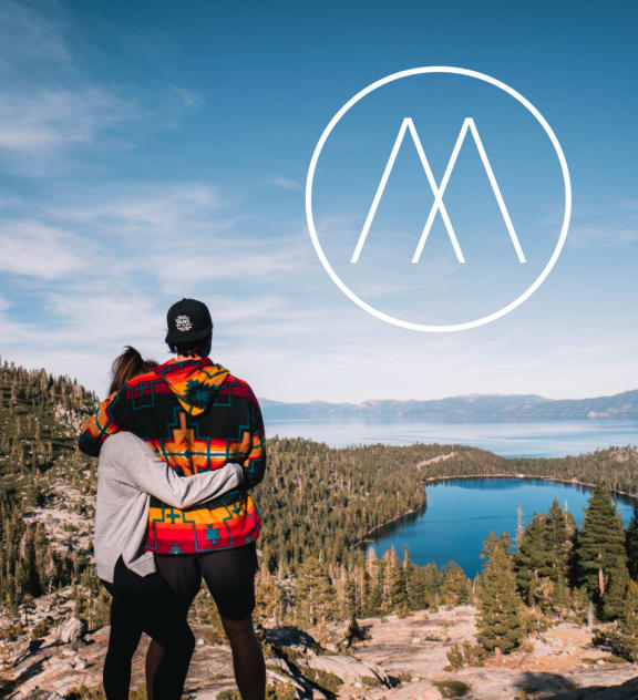 Man and Woman Holding Each Other while Admiring View