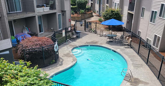 A small pool surrounded by a black fence.