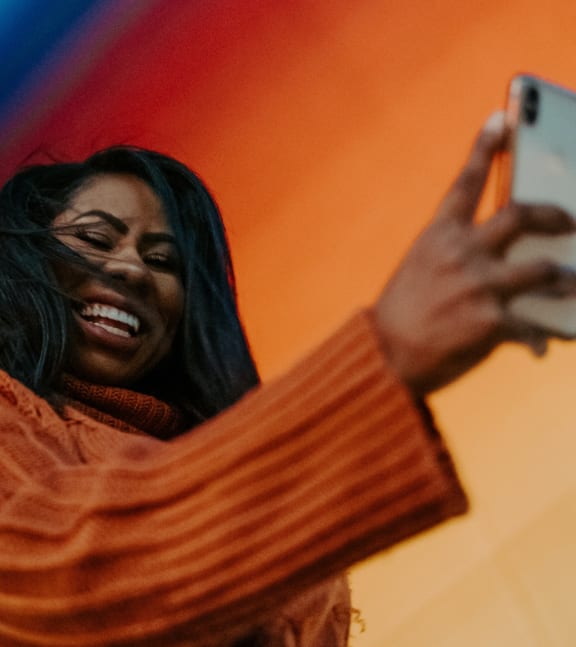 Woman Smiling While Holding Phone