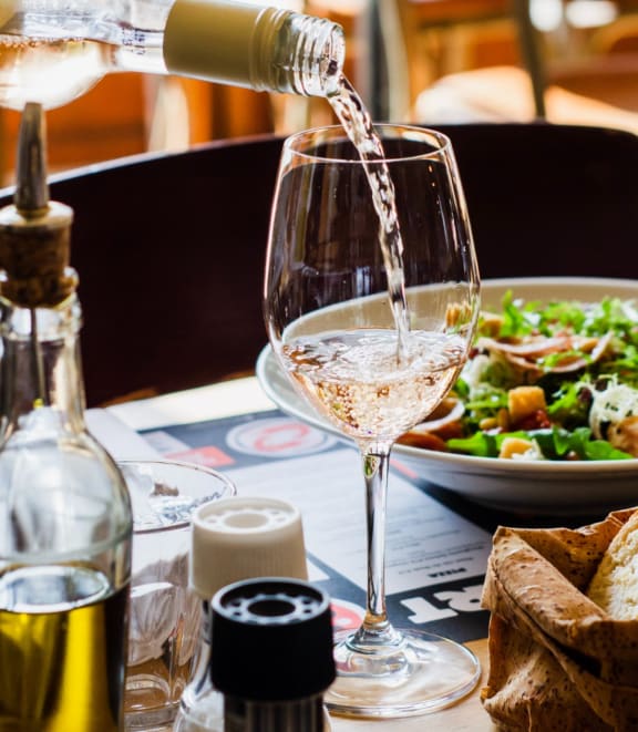 Wine Glass and Salad on Table