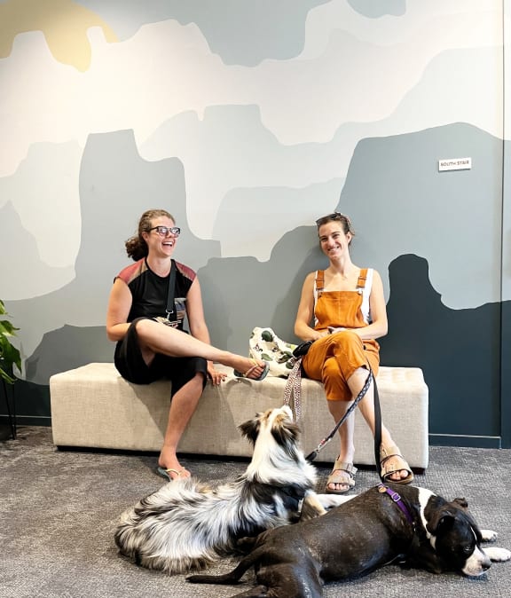 Residents at The Canyons in Portland, Oregon Smiling while Sitting on Bench with Dogs