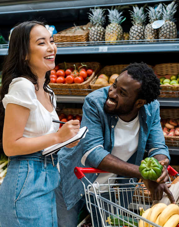A man and a woman are shopping for groceries together.