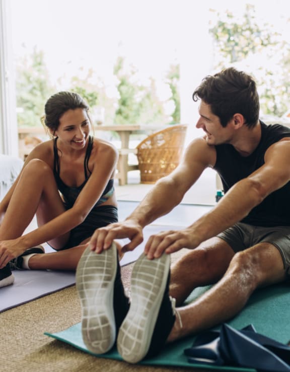 Man and Woman Stretching and Smiling Together