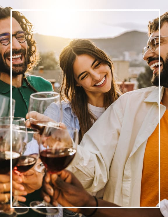 Friends Drinking Wine Outside and Smiling