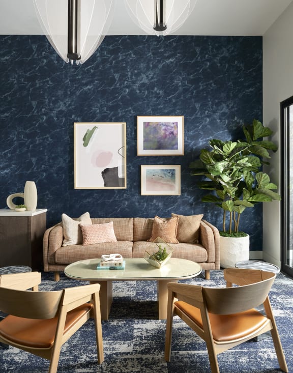 a living room with a blue wall and a couch and a table