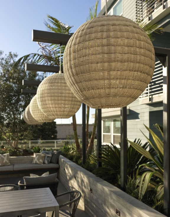 a patio with wicker umbrellas and tables and chairs