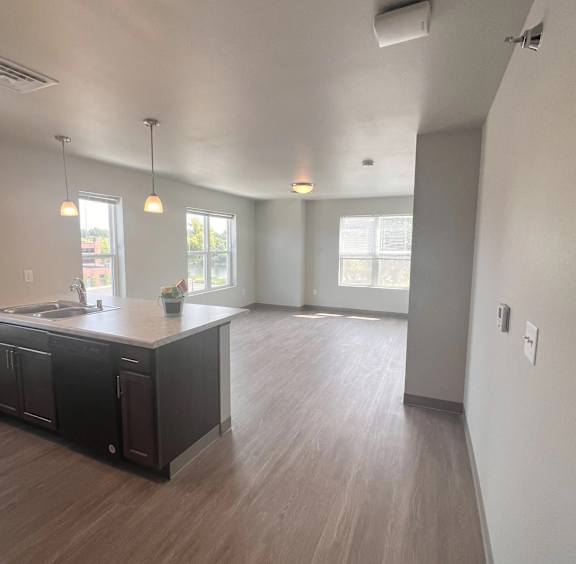 A kitchen with dark wood cabinets and a white countertop.