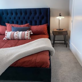 a bedroom with a bed and a nightstand with a lamp  at Timber Ridge, Minnesota