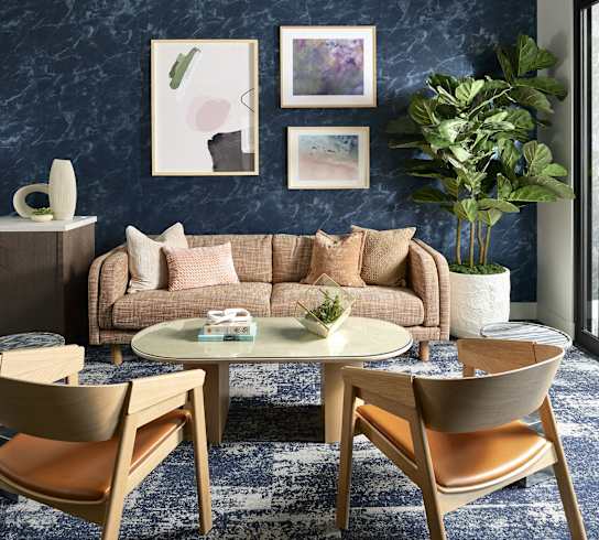 a living room with a blue wall and a couch and a table