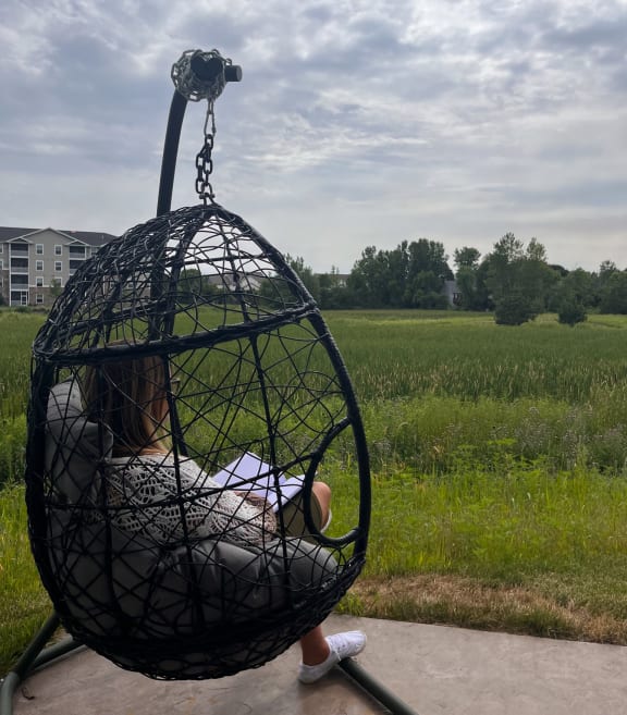 a child is sitting in a bird cage on a swing  at Timber Ridge, Forest Lake, 55025