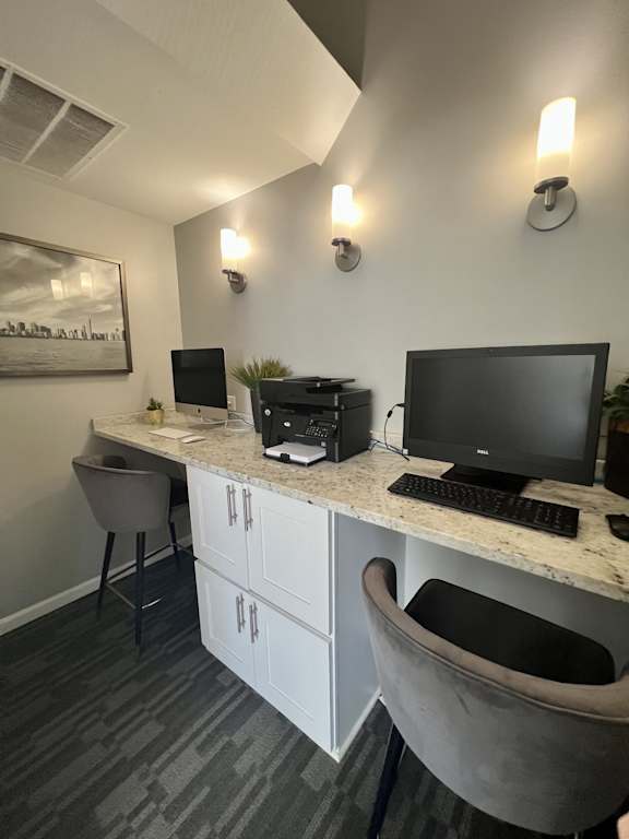 A modern office with a desk, chair, and computer.