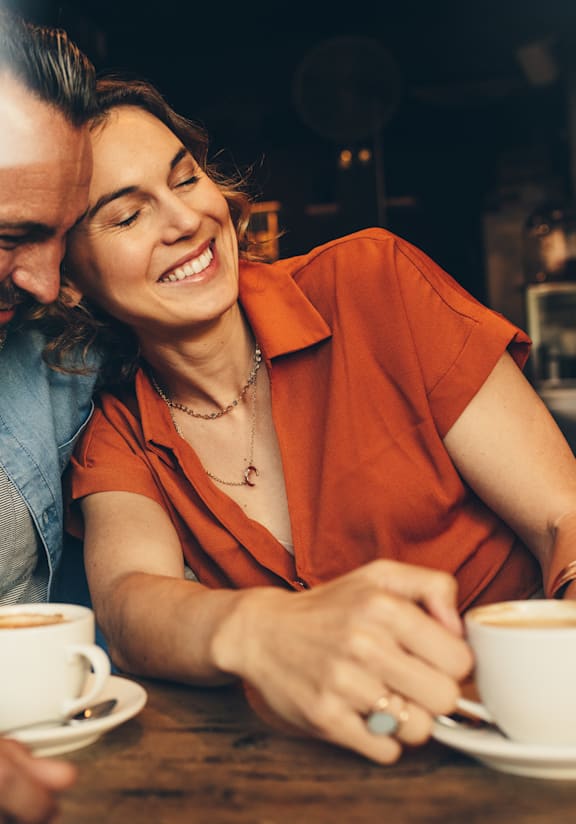 Woman Smiling while Leaning Against Man