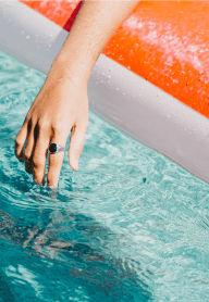 Woman Putting Hand in Pool
