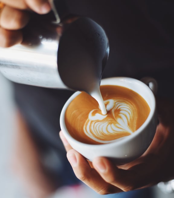 a cup of coffee with latte graphics