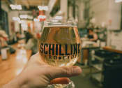 Thumbnail 4 of 14 - Man Holding Glass of Beer at Brewery