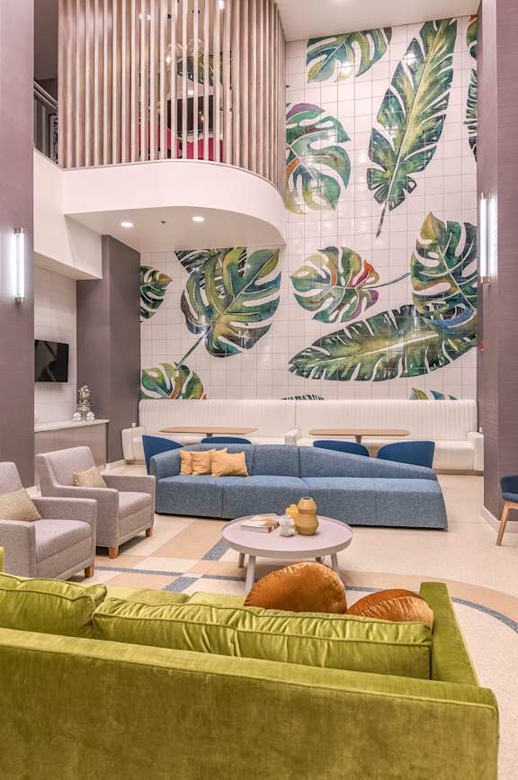 a lobby with couches and chairs and a wall mural of bananas at Paramount on Lake Eola, Florida, 32801