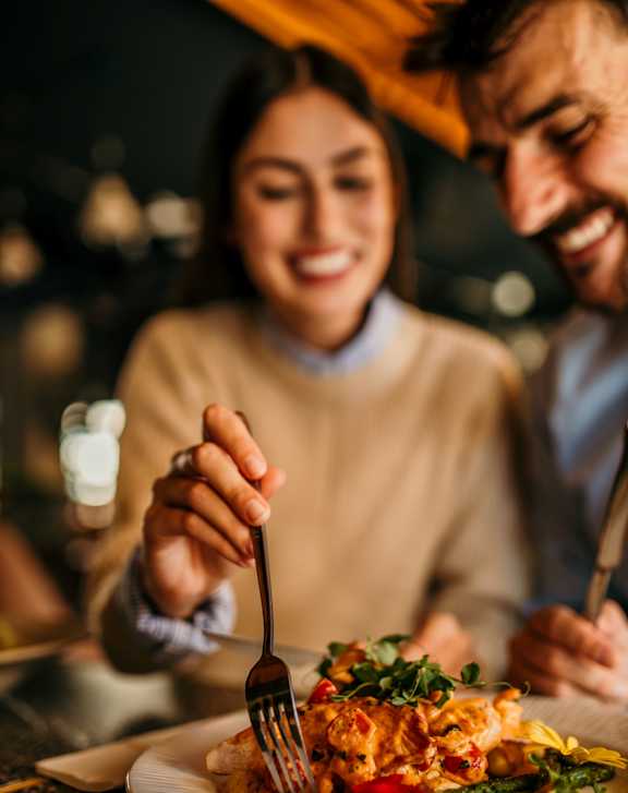 A man and woman are enjoying a meal together.