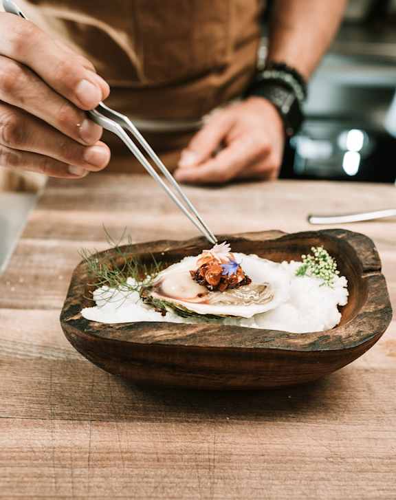A person is eating a dish with a fork at Vineland Gardens, Studio City, 91602