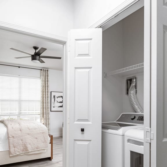 a bathroom with green and white shower curtains and a white vanity with a white sink and toilet
