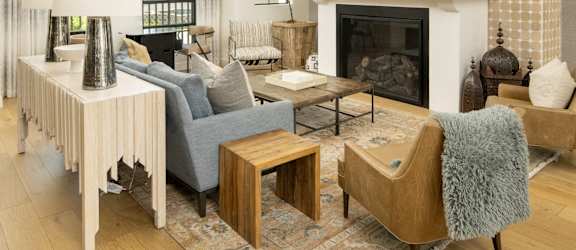 A living room with a fireplace and a TV mounted on the wall.