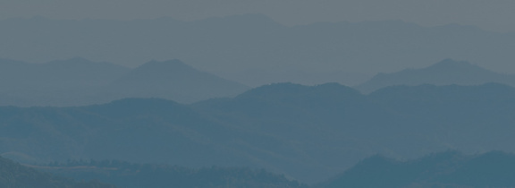 Aerial view of a scenic valley surrounded by mountains in Asheville, NC.