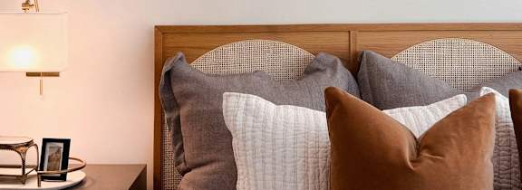 Model Bedroom with Wood Bed Frame Next to Wood Nightstand