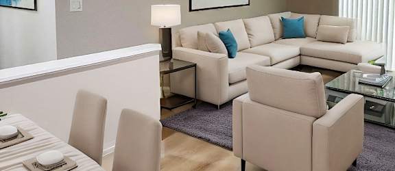 A modern living room with a dining table and a couch.
