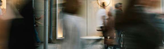 A group of people are walking in a hallway.