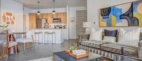 A modern living room with a grey couch and a coffee table.