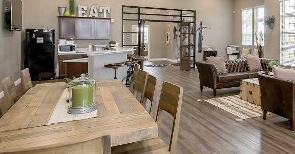 an open concept living room and dining room with a fireplace and a wooden dining table and chairs