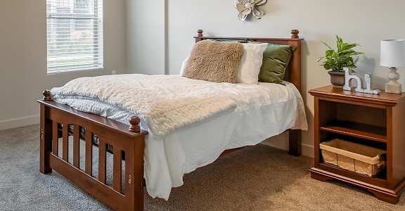 a bedroom with a bed and two night stands