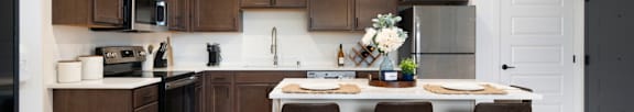 A kitchen with brown cabinets and a white countertop.