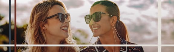 Two Women Wearing Sunglasses Smiling