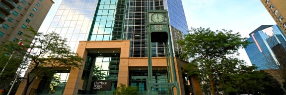 a clock tower in front of a tall building