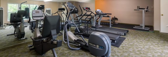 a room filled with lots of different types of exercise equipment