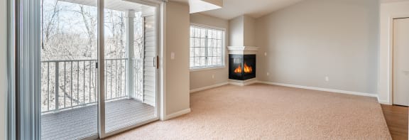 a living room with a fireplace and a balcony