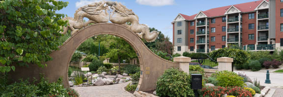 a stone archway with a lion sculpture on top of it