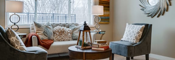 a living room filled with furniture and a large window