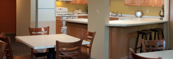 a kitchen with a table and chairs