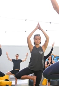 a group of people doing yoga in a yoga class