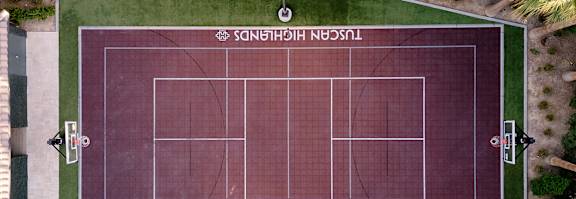 An aerial view of a tennis court with the name "Tuscan Highlands" written on it.