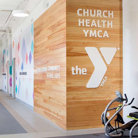 the gym at the ymca with bikes parked against the wall