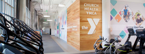 the gym at the ymca with bikes parked against the wall