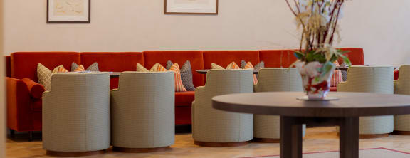 a lounge chair in front of a large window in a hotel lobby