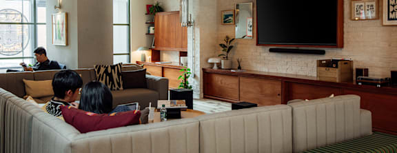a lounge chair in front of a large window in a hotel lobby