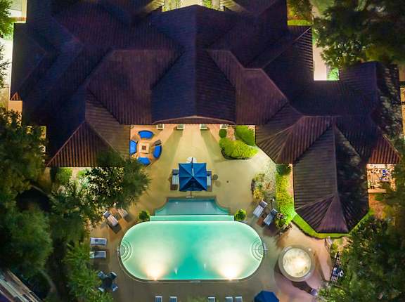 arial view of a house with a swimming pool at night