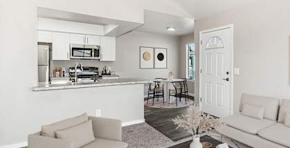 Model apartment living room and kitchen with a couch