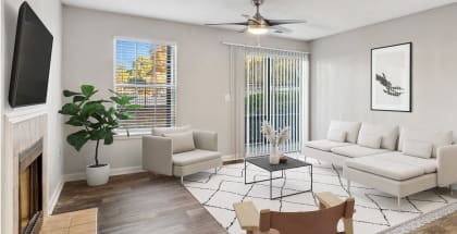 Model apartment living room with white furniture and a ceiling fan