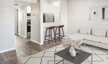 Model apartment living room with a white couch and a coffee table